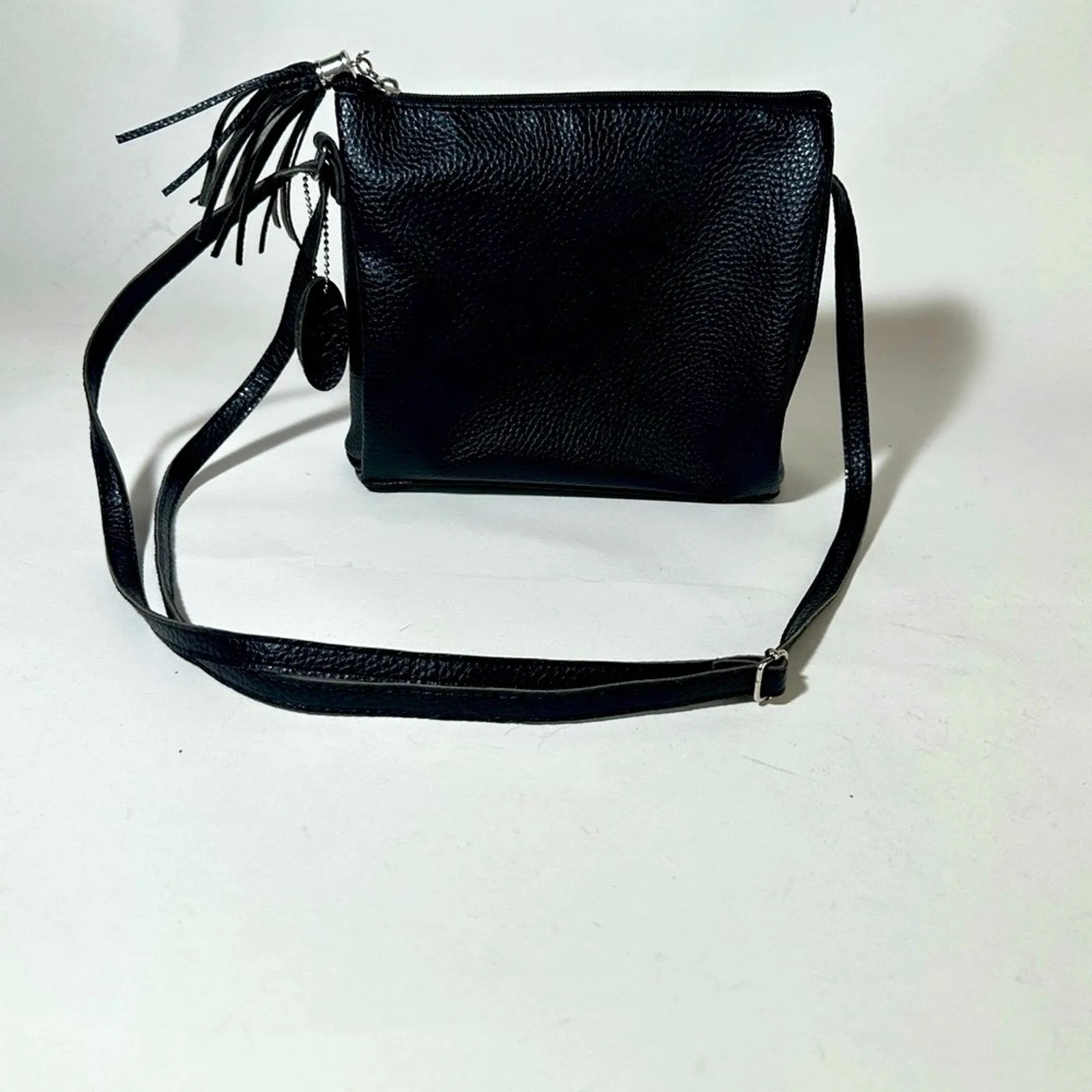 Sleek Black Crossbody Bag with Adjustable Strap and Tassel
