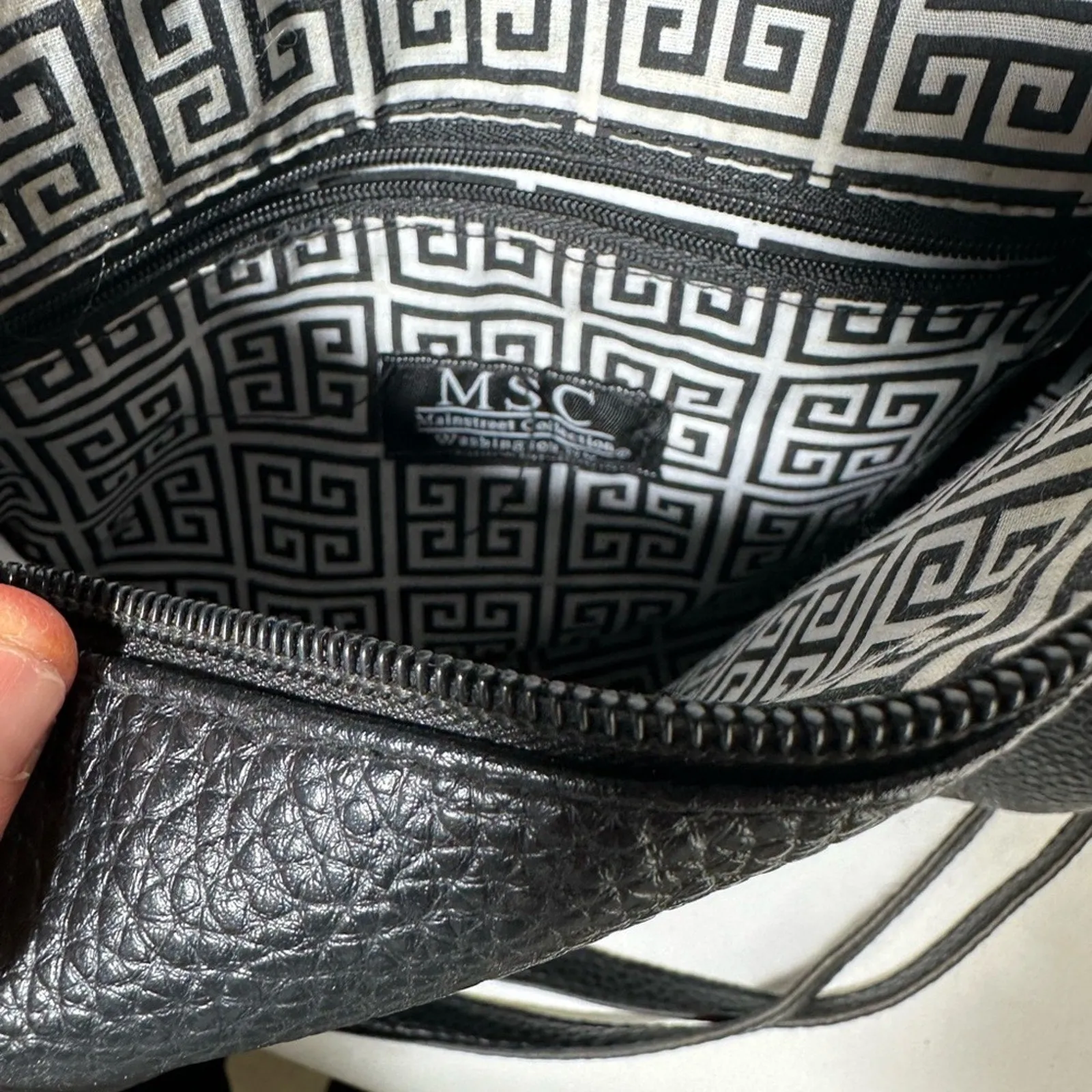 Sleek Black Crossbody Bag with Adjustable Strap and Tassel