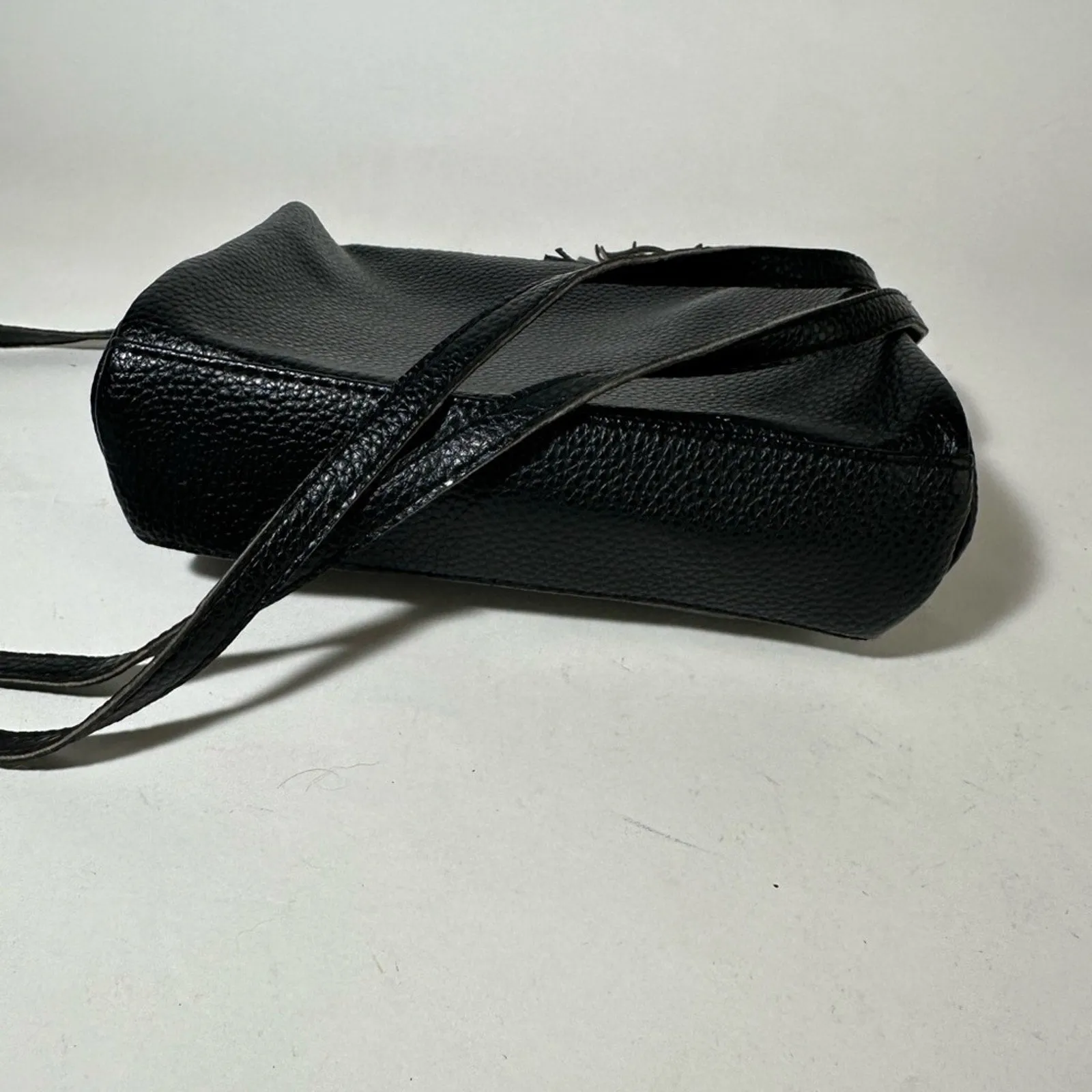 Sleek Black Crossbody Bag with Adjustable Strap and Tassel
